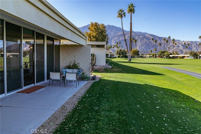 view of yard featuring a mountain view and a patio area