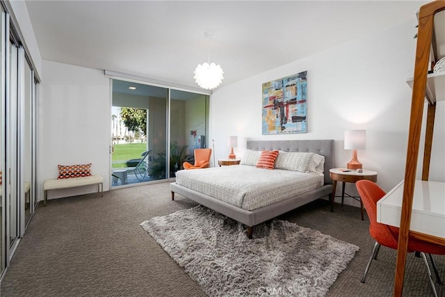 carpeted bedroom featuring access to outside, an inviting chandelier, and a closet