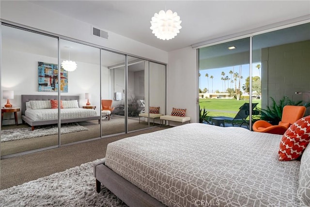 carpeted bedroom featuring a notable chandelier