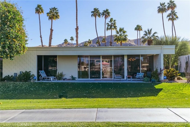 rear view of house with a lawn