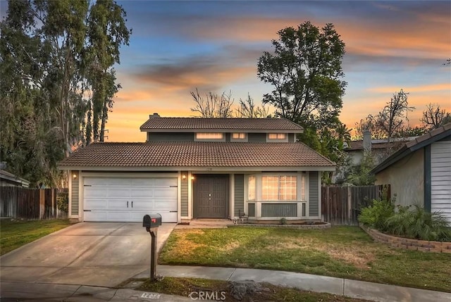 view of front of house featuring a garage and a lawn