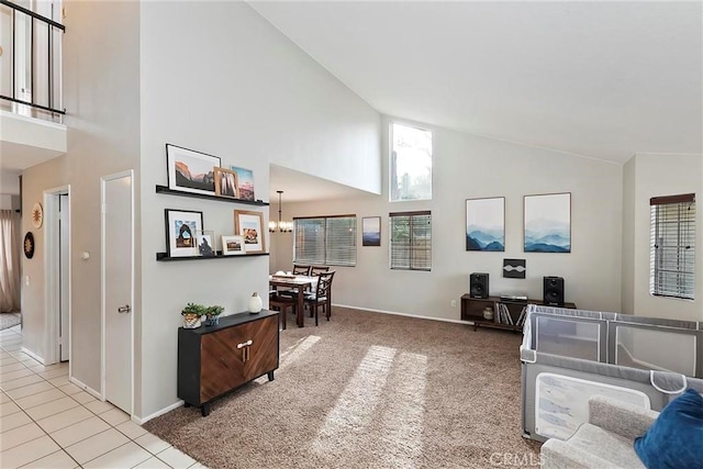 living room with light tile patterned flooring, a notable chandelier, and high vaulted ceiling