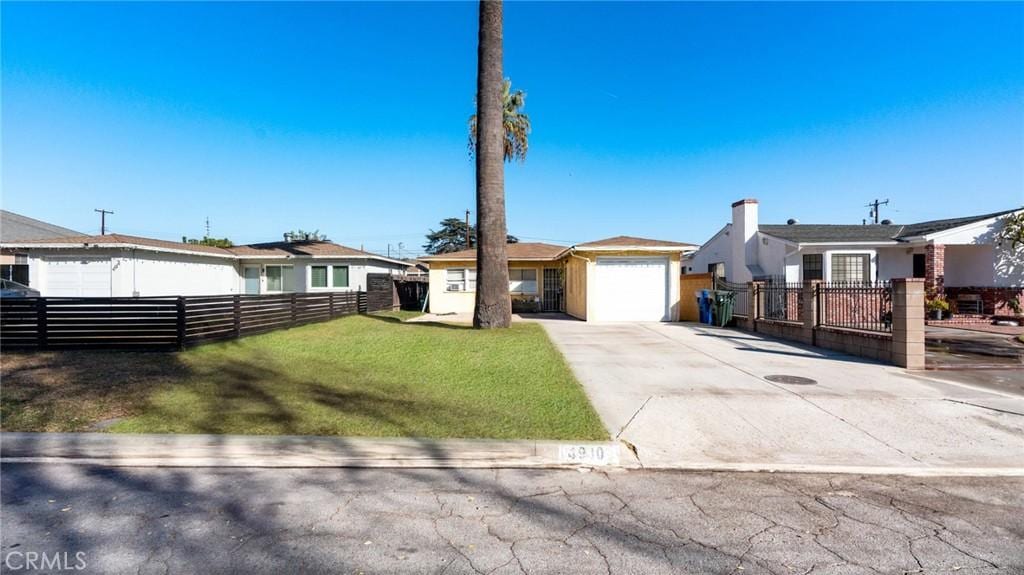 view of front of property featuring a garage and a front lawn