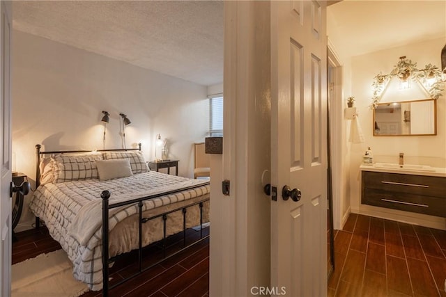 bedroom featuring sink and a textured ceiling