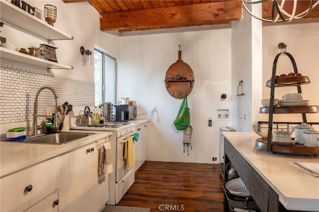 kitchen featuring sink, white gas stove, wooden ceiling, dark hardwood / wood-style floors, and beamed ceiling