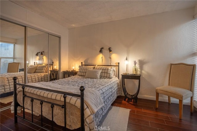 bedroom with a textured ceiling and a closet