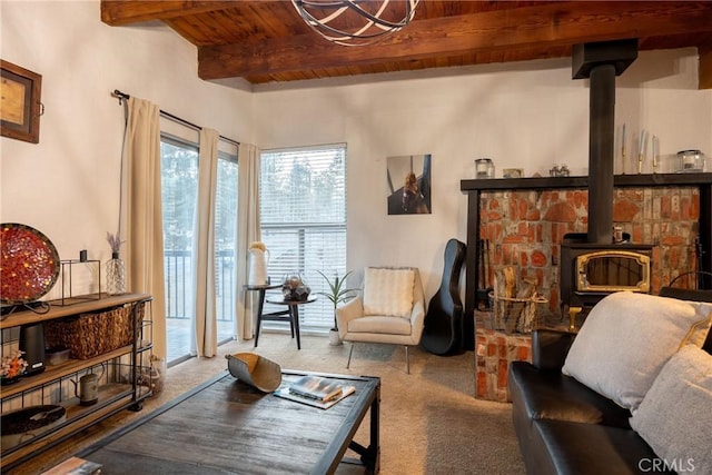 living room with beamed ceiling, a wood stove, and wood ceiling