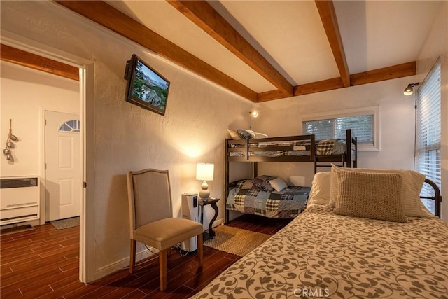 bedroom featuring radiator and beamed ceiling