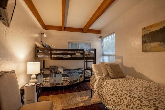 bedroom featuring beamed ceiling and dark hardwood / wood-style floors