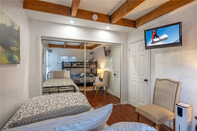 bedroom with beamed ceiling and a closet