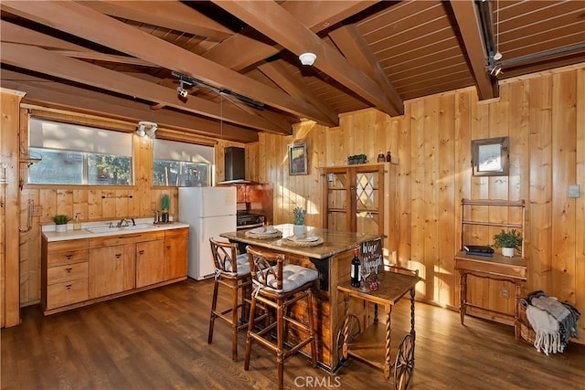 dining room featuring lofted ceiling with beams, rail lighting, dark hardwood / wood-style flooring, and wood ceiling