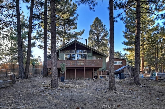 rear view of house featuring a deck