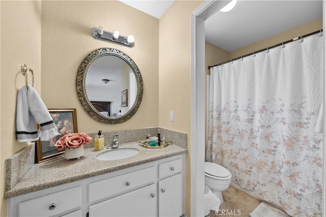 bathroom featuring vanity, tile patterned flooring, and toilet