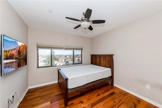 bedroom with dark wood-type flooring and ceiling fan