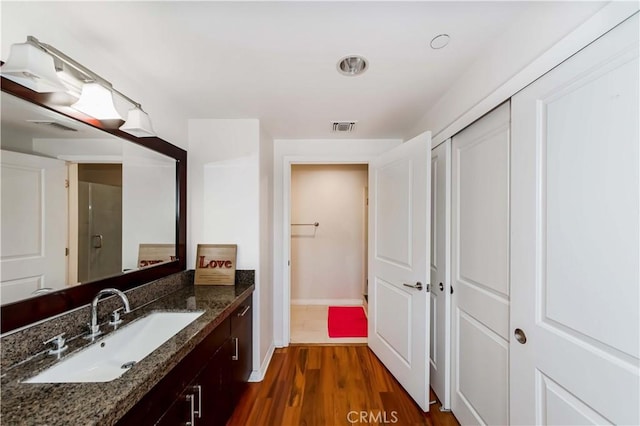 bathroom with vanity and hardwood / wood-style floors