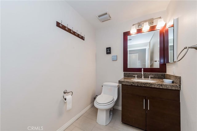 bathroom featuring vanity, tile patterned flooring, and toilet