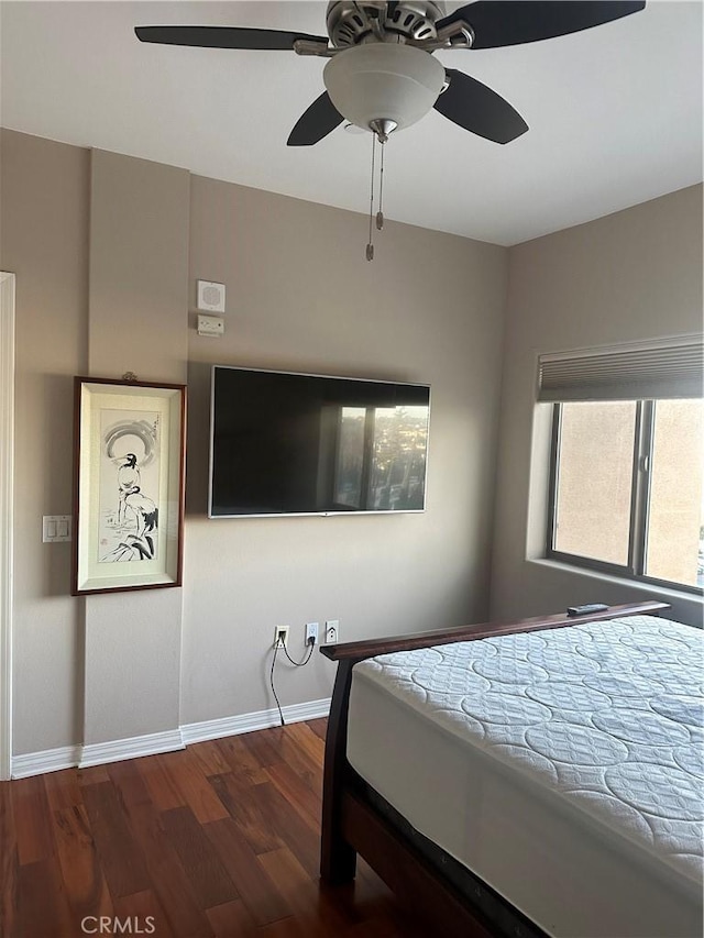 bedroom with dark wood-type flooring and ceiling fan