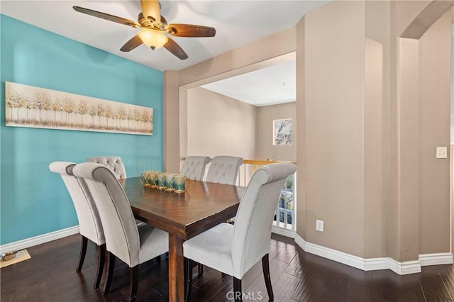 dining area featuring ceiling fan and dark hardwood / wood-style flooring