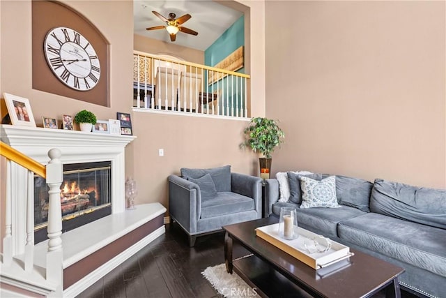 living room featuring dark hardwood / wood-style flooring and ceiling fan