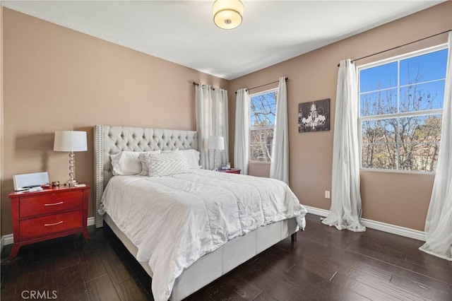 bedroom with dark wood-type flooring