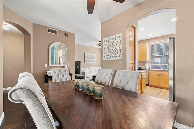 tiled dining room featuring ceiling fan