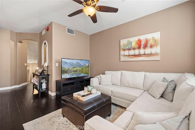 living room featuring ceiling fan and dark hardwood / wood-style flooring