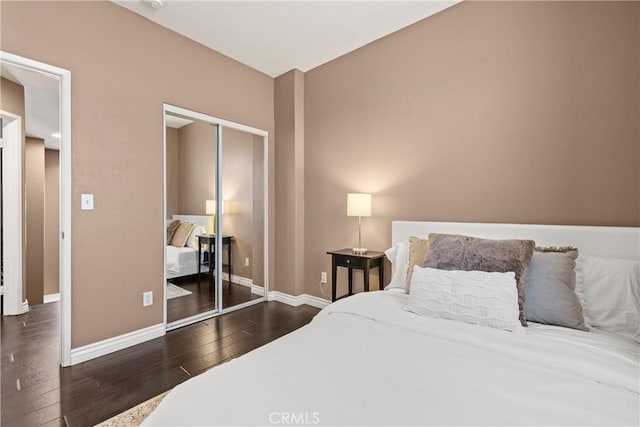 bedroom featuring dark hardwood / wood-style floors and a closet