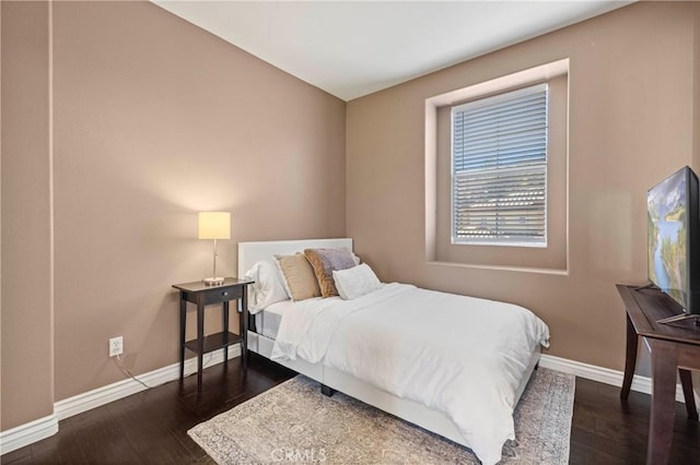 bedroom with dark hardwood / wood-style floors