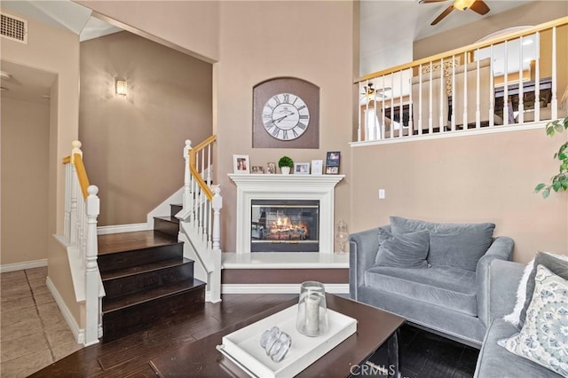 living room featuring ceiling fan and hardwood / wood-style floors