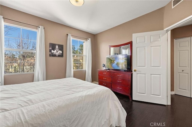 bedroom with dark hardwood / wood-style floors