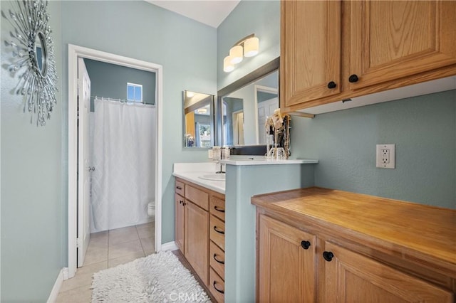 bathroom with tile patterned flooring, vanity, a shower with curtain, and toilet