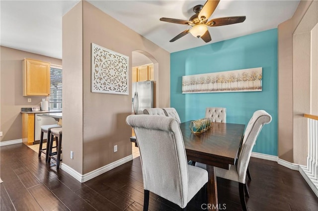 dining area with dark wood-type flooring and ceiling fan