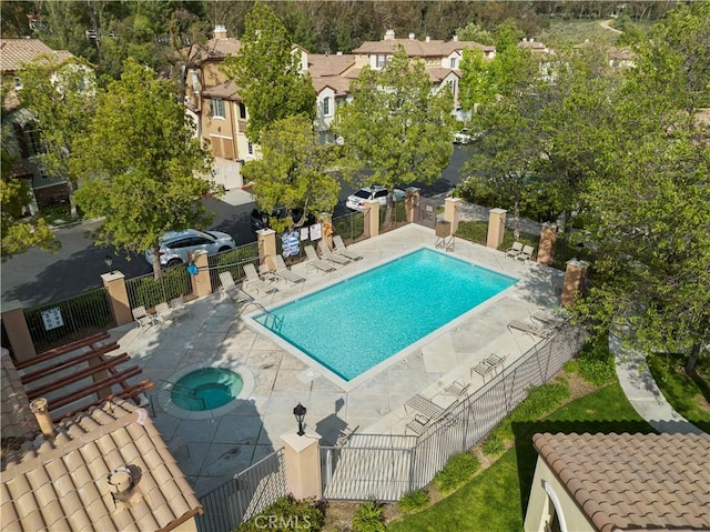 view of pool with a community hot tub and a patio area