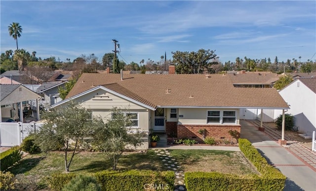 view of front of home with a carport and a front yard