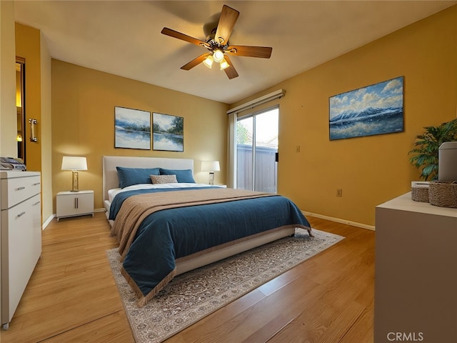 bedroom with access to exterior, light hardwood / wood-style floors, and ceiling fan