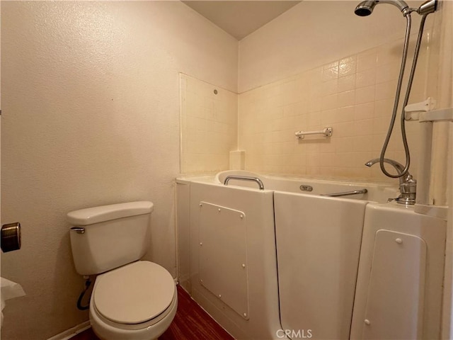 bathroom featuring a bathing tub and toilet