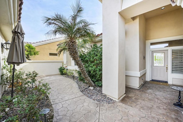 entrance to property featuring a patio