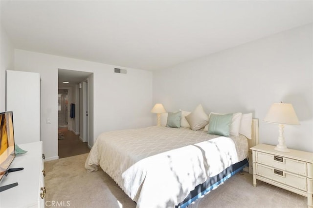 bedroom featuring light colored carpet