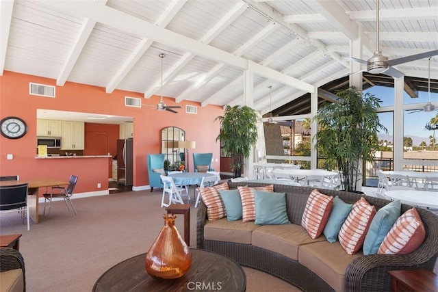 interior space with ceiling fan and vaulted ceiling with beams