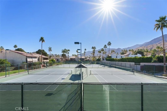 view of tennis court featuring a mountain view