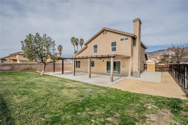 rear view of house with a patio area and a lawn