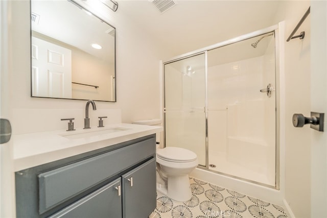 bathroom with tile patterned floors, vanity, toilet, and an enclosed shower