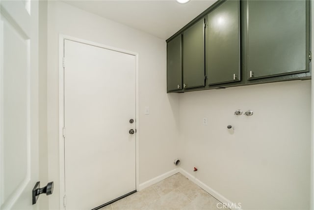 washroom featuring gas dryer hookup, light tile patterned floors, washer hookup, and cabinets