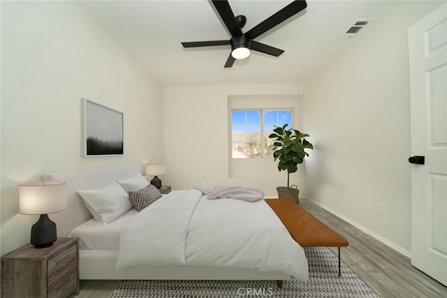 bedroom with ceiling fan and light hardwood / wood-style flooring