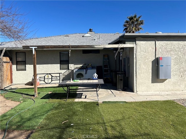 rear view of property featuring a yard and a patio area