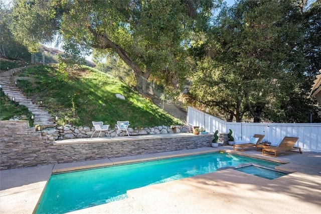 view of swimming pool featuring a fenced backyard, stairs, and a patio