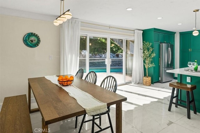 dining space with marble finish floor and recessed lighting