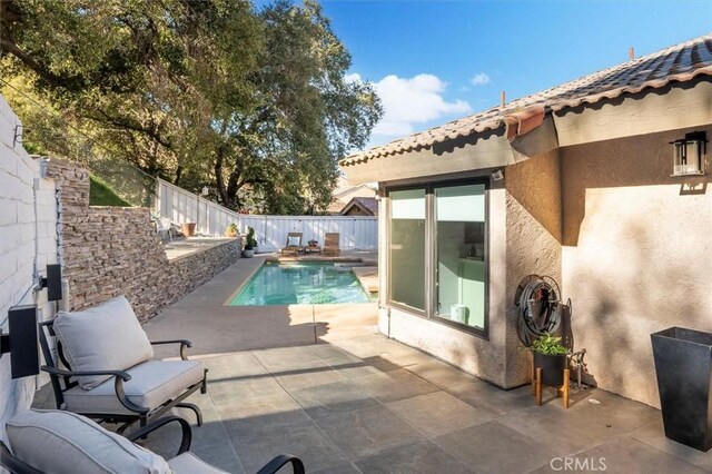 view of pool featuring a fenced backyard, a fenced in pool, and a patio