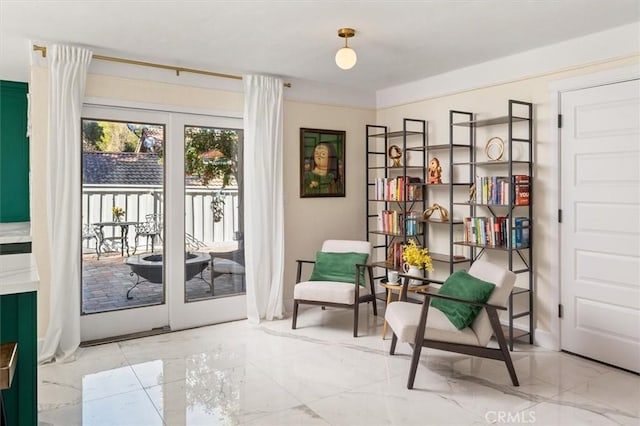 sitting room featuring marble finish floor