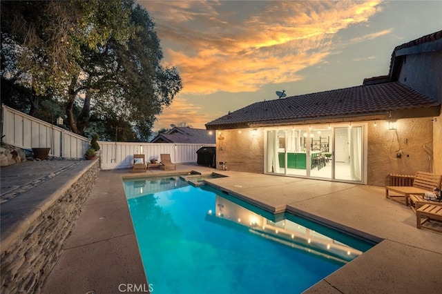 view of pool featuring a patio, a fenced backyard, and a fenced in pool